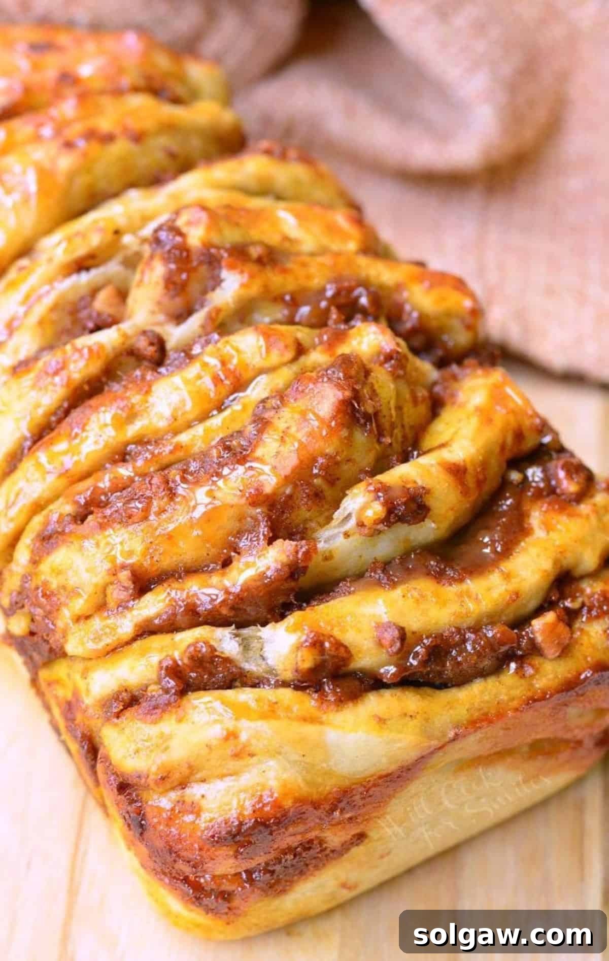 closeup of baked pumpkin pull apart bread on the cutting board.