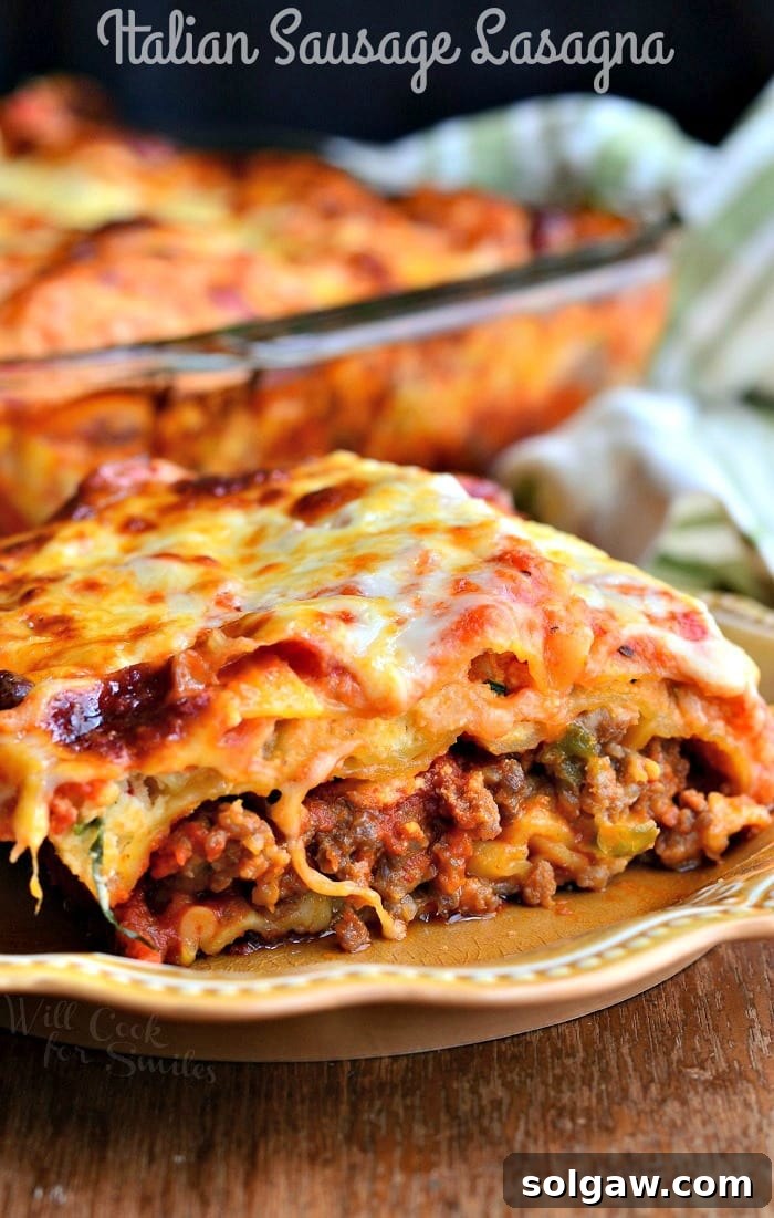 Ultimate Italian Sausage Lasagna 2 A perfectly portioned slice of spicy Italian Sausage Lasagna on a white plate, showcasing its rich layers of pasta, meat, and cheese.