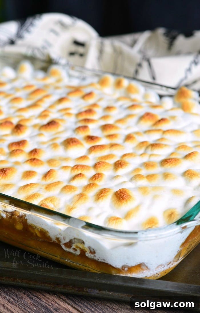 Sweet Potato Casserole Cake in a glass baking dish with melted marshmallows on top