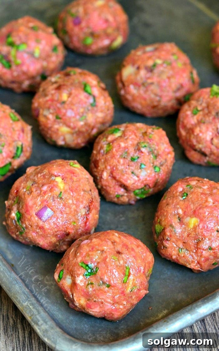 Grandma's Albondigas Soup 3 uncooked Mexican Meatballs on a baking sheet