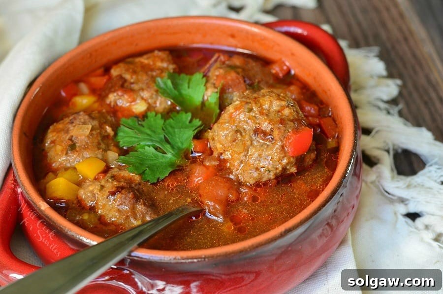 Grandma's Albondigas Soup 4 Mexican Meatballs Soup in a bowl with a spoon in it