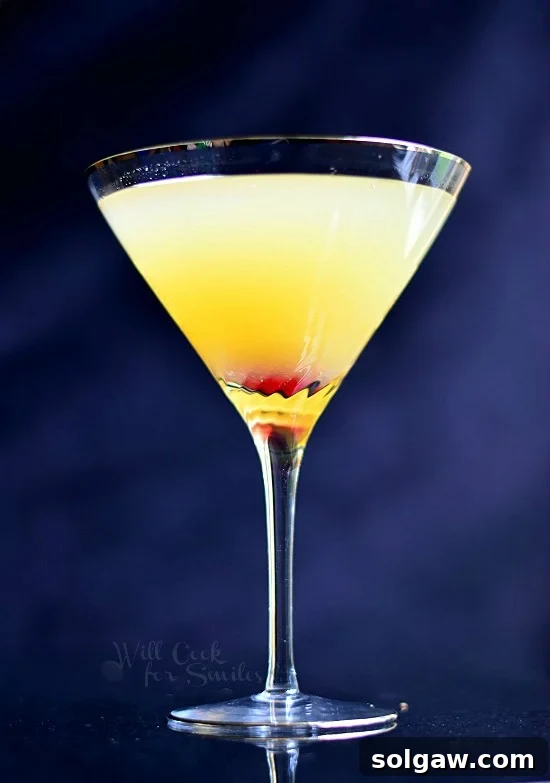 Flirtini in a martini glass with a cherry at the bottom of glass