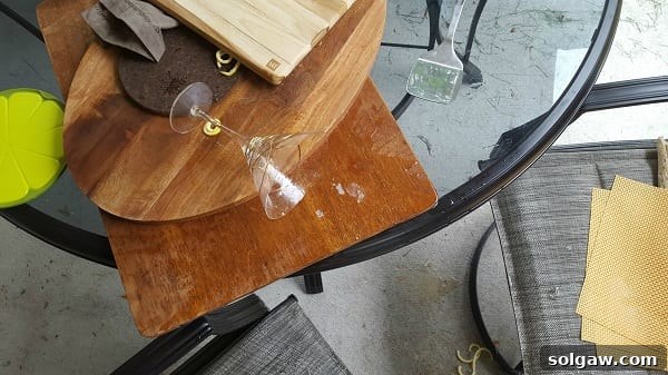 top view photo of Martini glass knocked over on a stack of wood cutting boards