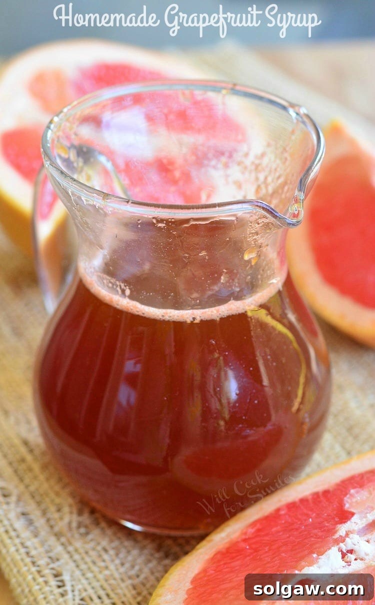 Homemade Grapefruit Syrup in a glass jar, perfectly clear and golden, ready for use.