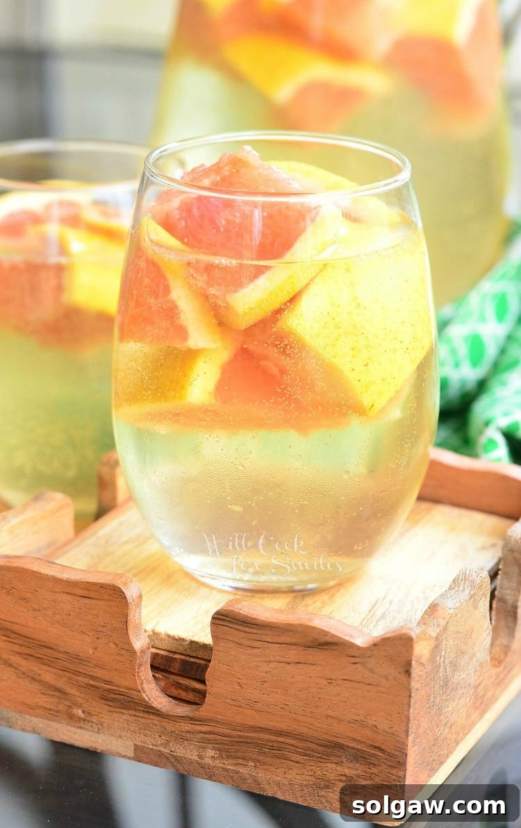 Fresh Grapefruit Sangria in a stemless wine glass, garnished with grapefruit slices, exuding a cool and refreshing vibe.