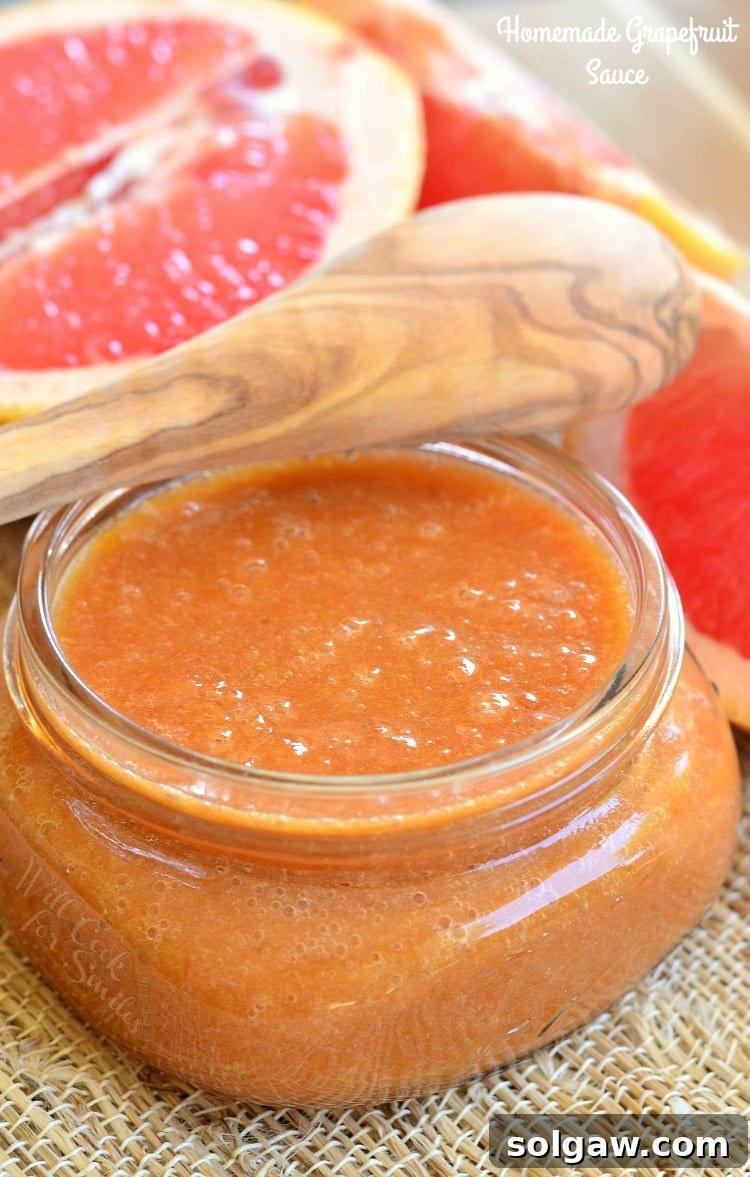 Homemade Grapefruit Sauce in a glass jar, showcasing its thicker, richer texture.