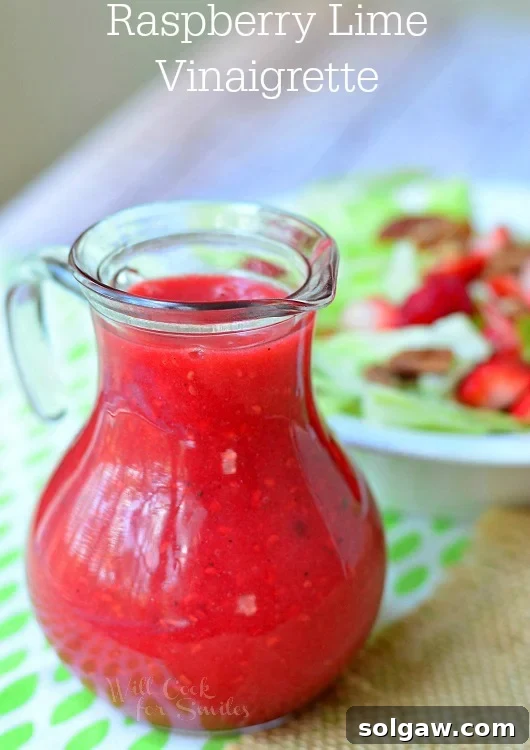 Blackberry Poppy Seed Chicken Spinach Salad 11 Refreshing Raspberry Lime Vinaigrette in a glass container.