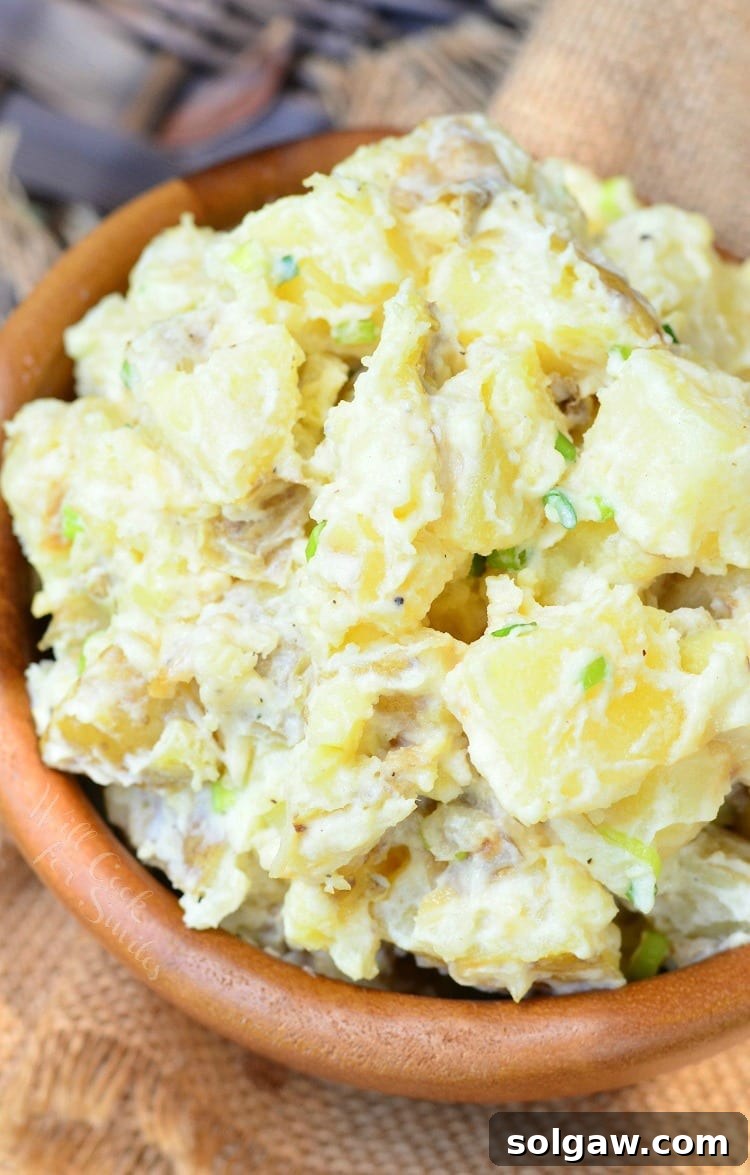 Savory Roasted Garlic Asiago Potato Salad 2 Wooden bowl filled with roasted garlic asiago potato salad on a tan cloth as viewed from above