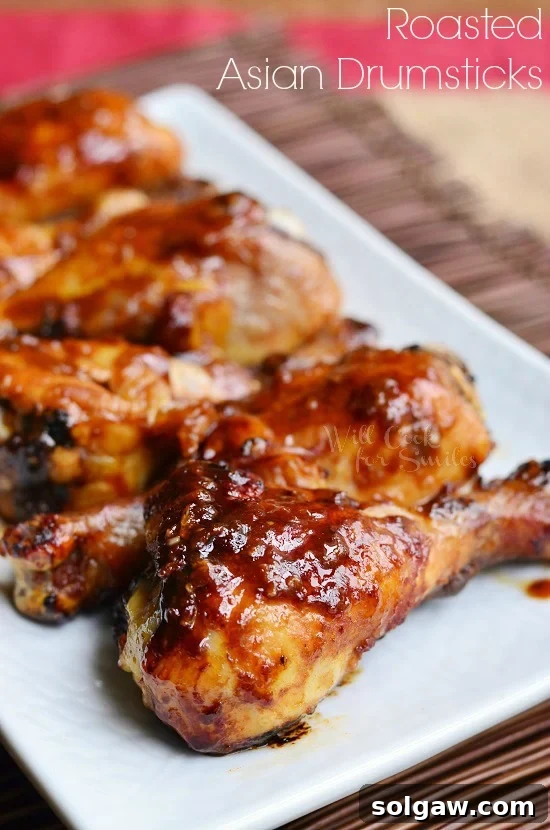 Asian Roasted Drumsticks arranged beautifully on a white serving plate, garnished with green onions.
