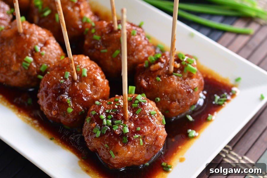 Honey Garlic Teriyaki Chicken Meatballs with toothpicks ready to serve on a white serving tray