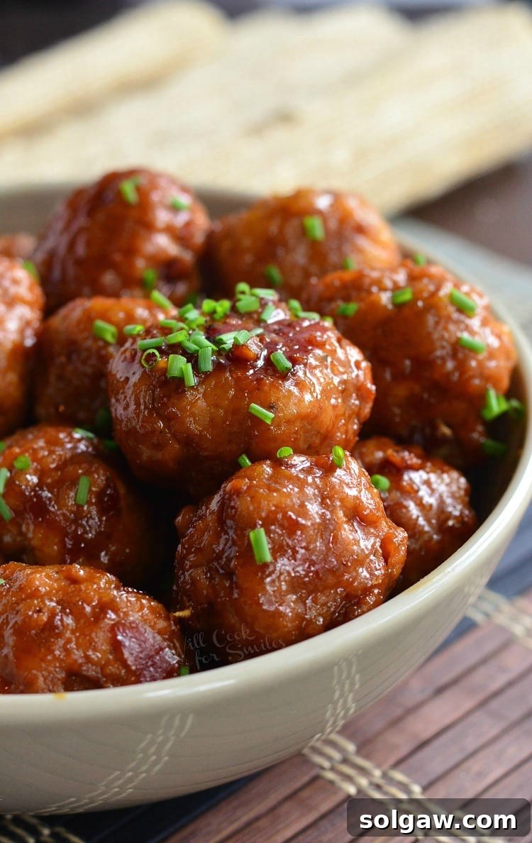 Sticky Honey Garlic Teriyaki Chicken Meatballs 5 Close-up of Honey Garlic Teriyaki Chicken Meatballs glistening in a white bowl