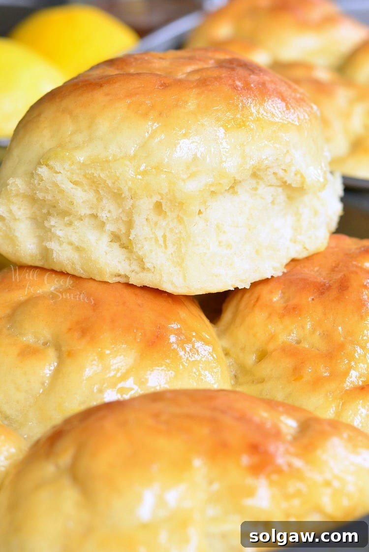 Honey Lemon Dinner Rolls stacked on a baking sheet, golden brown and inviting