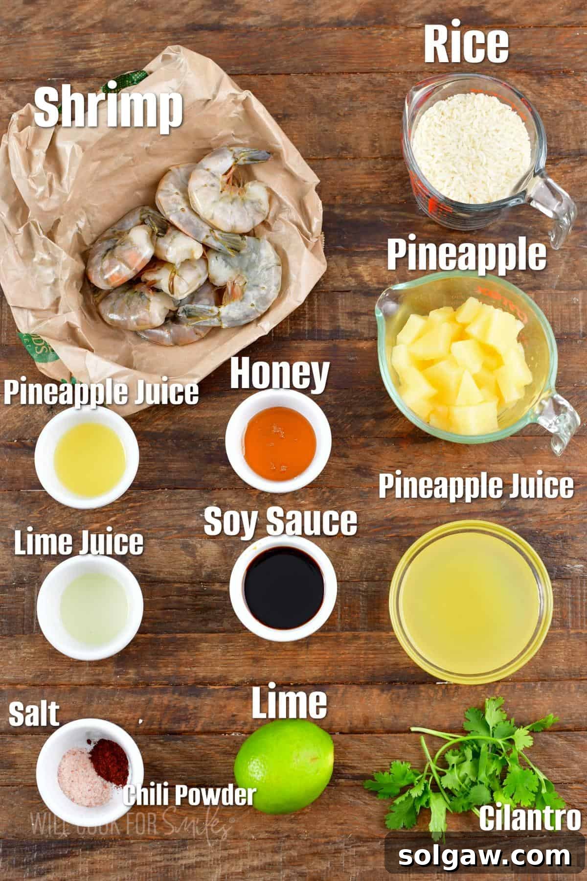 Island Shrimp Rice Bowl 3 All the fresh ingredients required for preparing the Tropical Shrimp Rice Bowl, neatly arranged on a rustic wooden surface, highlighting fresh shrimp, pineapple, and cilantro.