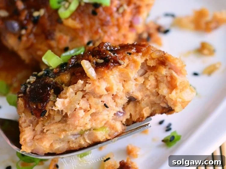 cut salmon and rice patty on a fork