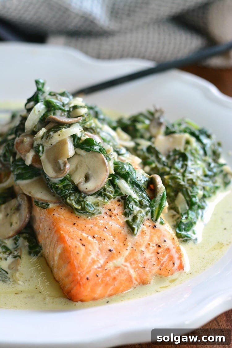 Emerald Florentine Salmon 2 A beautifully plated salmon Florentine dish, topped with creamy spinach and mushrooms, ready to be enjoyed.