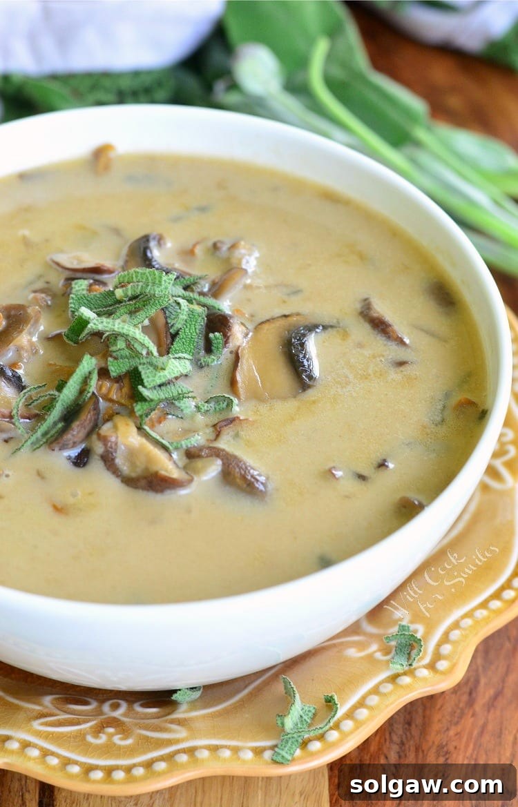 The BEST Mushroom Soup in a bowl on a yellow plate