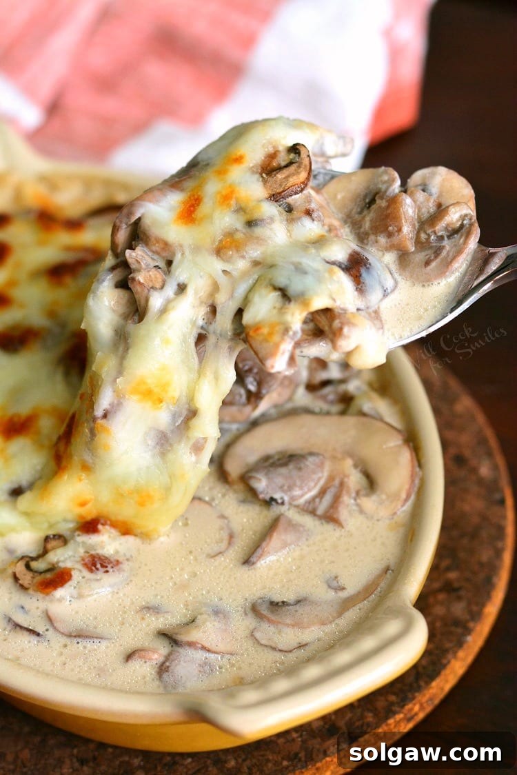 Creamy Russian Mushroom Julienne in casserole dish with spoon scooping some out