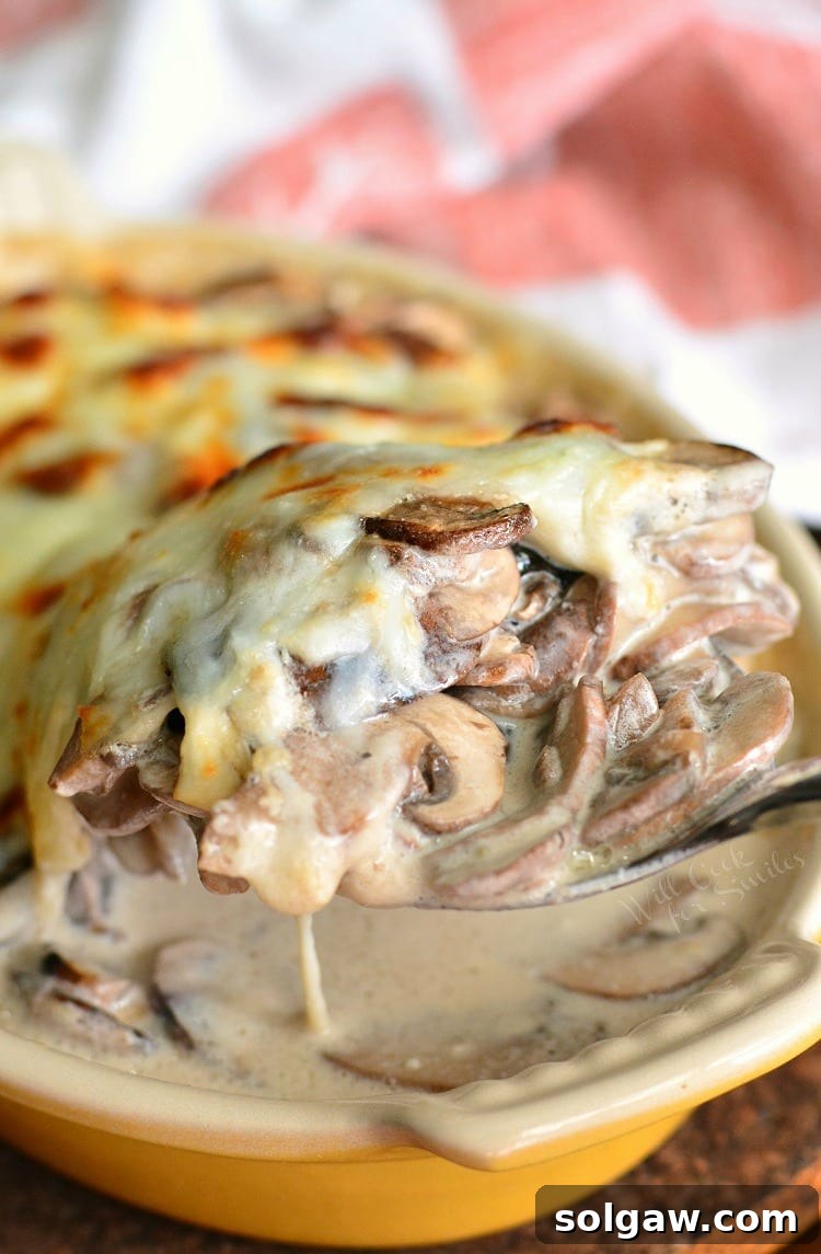 Creamy Russian Mushroom Julienne in casserole dish with a spoon