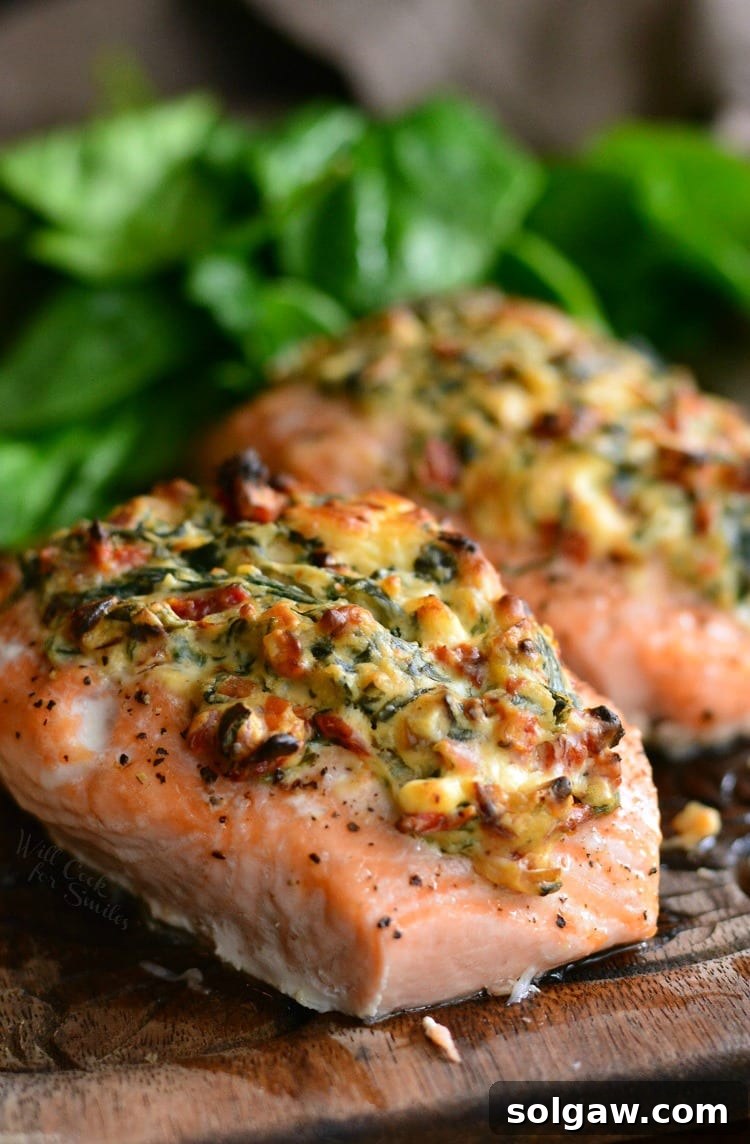 Salmon Bursting with Creamy Spinach and Sun-Dried Tomatoes 5 A perfectly cooked piece of creamy spinach and sun-dried tomato stuffed salmon, ready to eat.