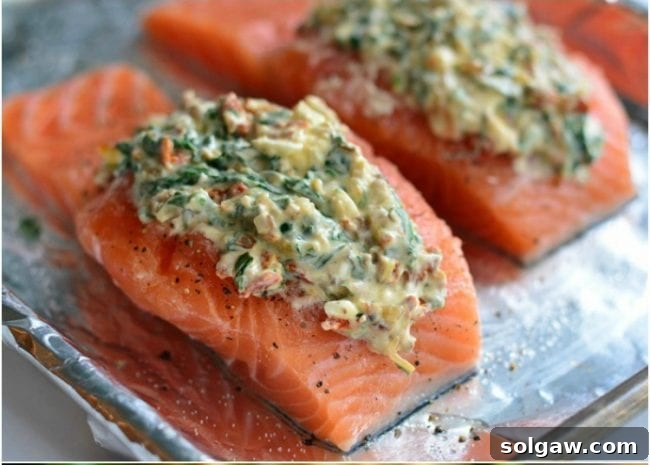 Salmon Bursting with Creamy Spinach and Sun-Dried Tomatoes 6 Close up of salmon fillet being stuffed with creamy filling