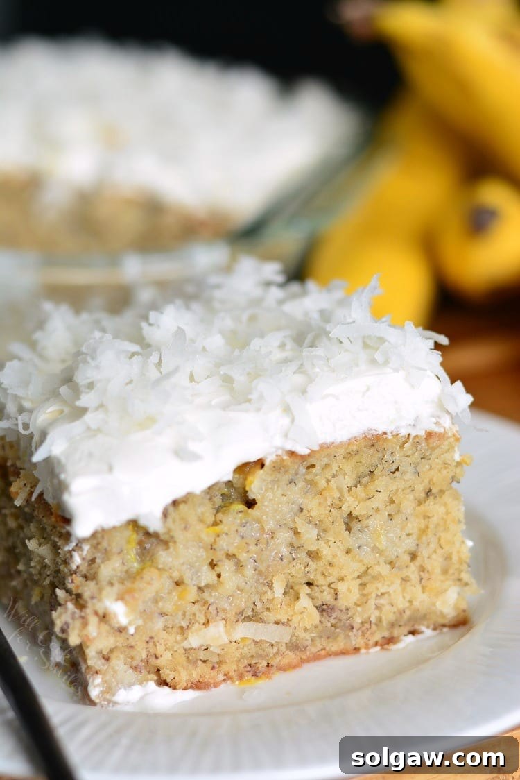 Lemon Coconut Banana Poke Cake on a plate, ready to be served