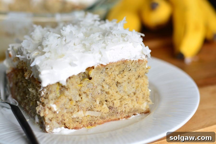 Lemon Coconut Banana Poke Cake on a large plate, ready to be enjoyed