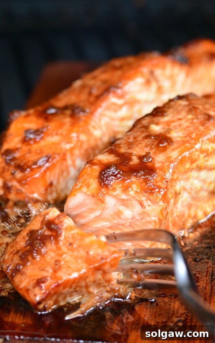 Honey Ginger Glazed Cedar Plank Salmon 4 Honey Ginger Cedar Plank Salmon cooked and on the cedar plank with a fork