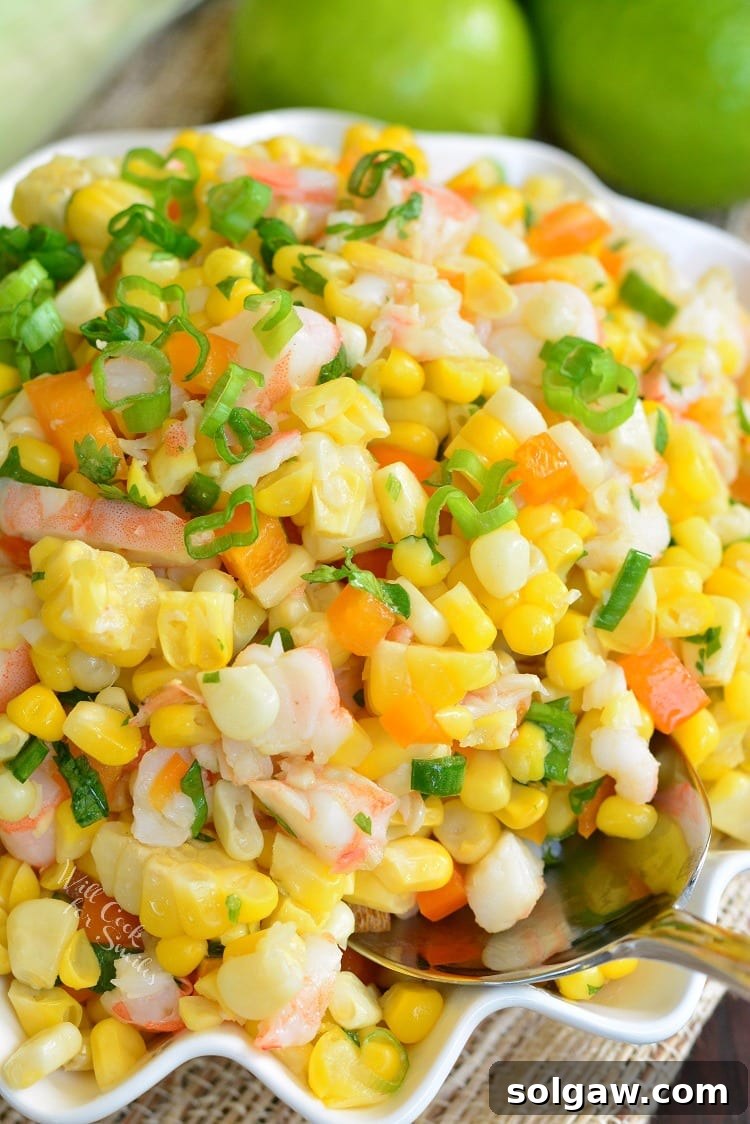Cilantro Lime Shrimp Corn Salad in a serving bowl with a metal spoon 