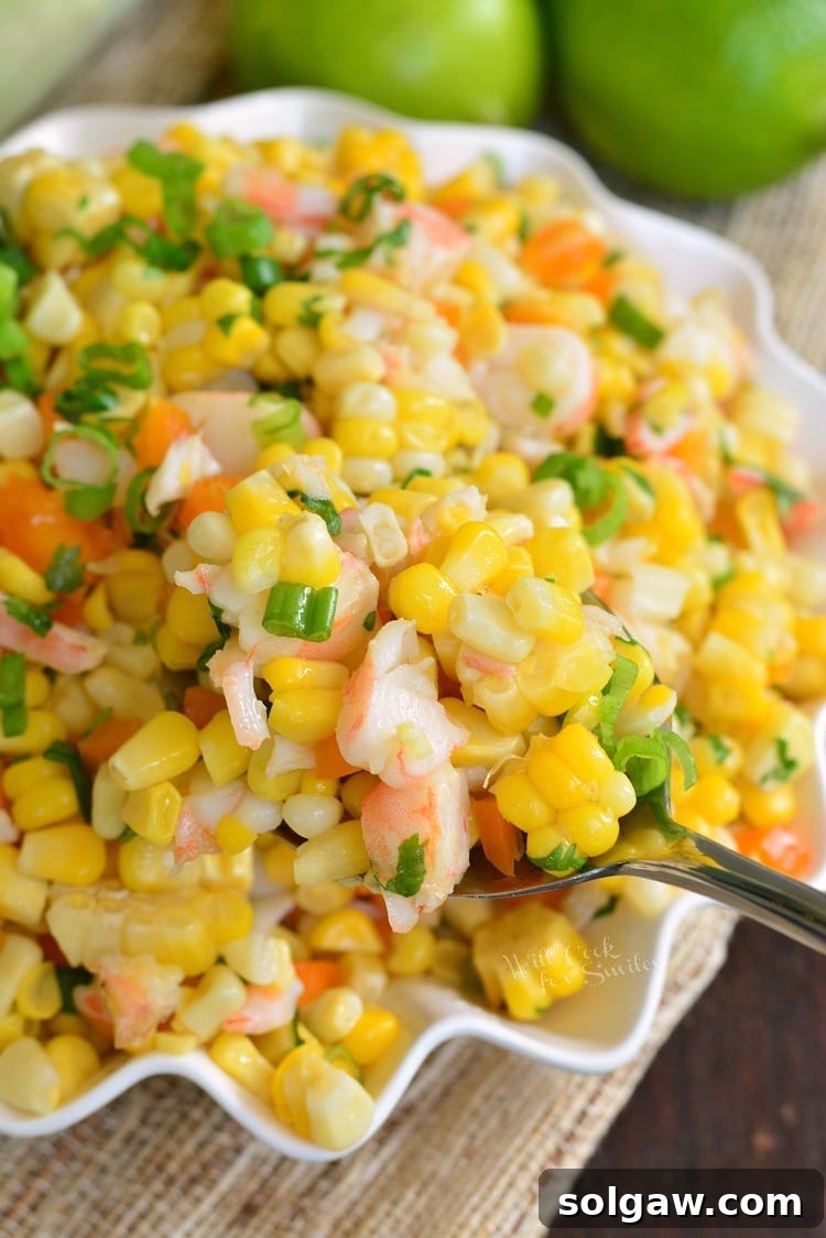 Cilantro Lime Shrimp Corn Salad in a bowl with a serving spoon 