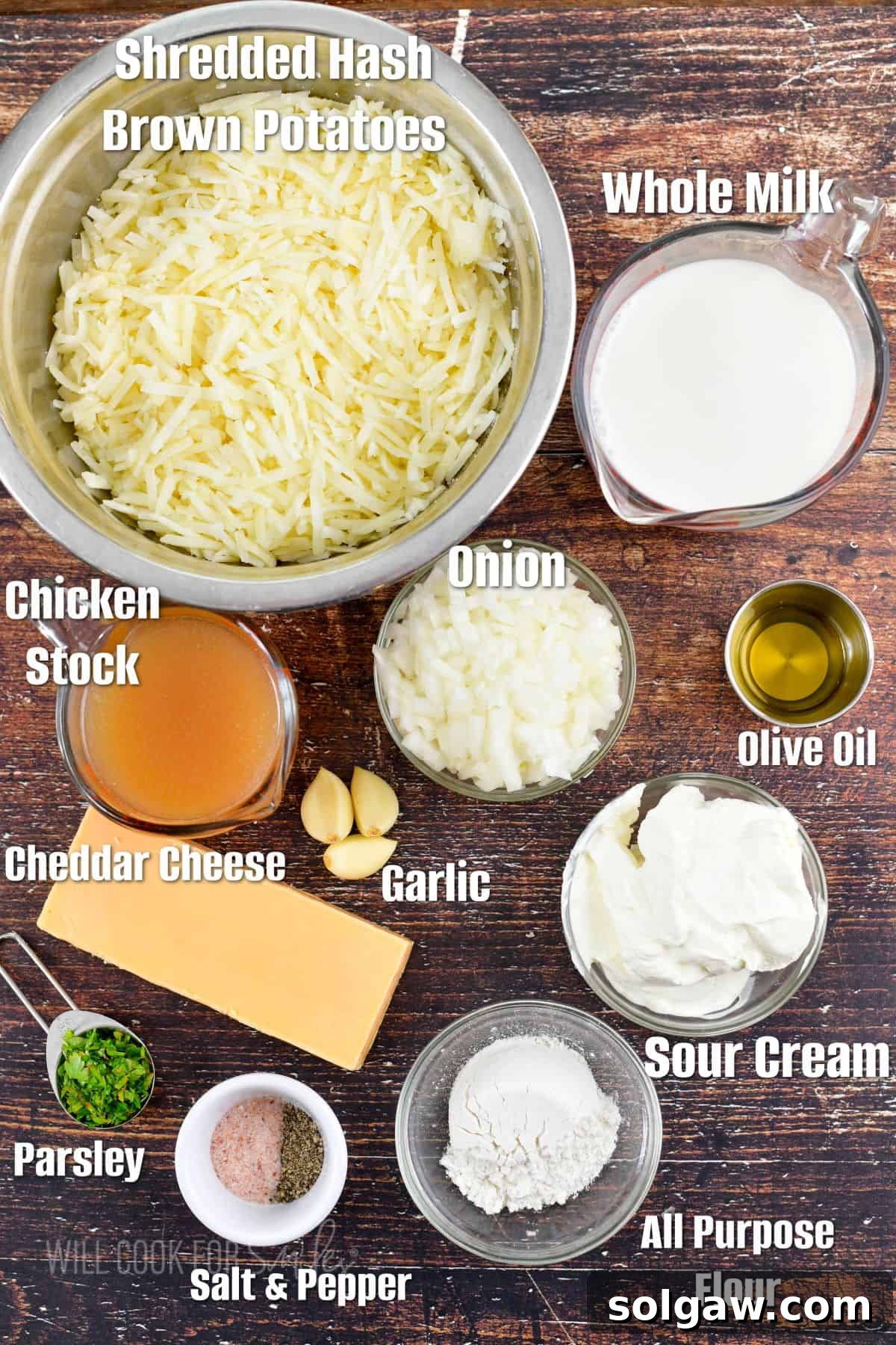 Labeled ingredients for hashbrown casserole arranged on a rustic wooden background, ready for preparation.