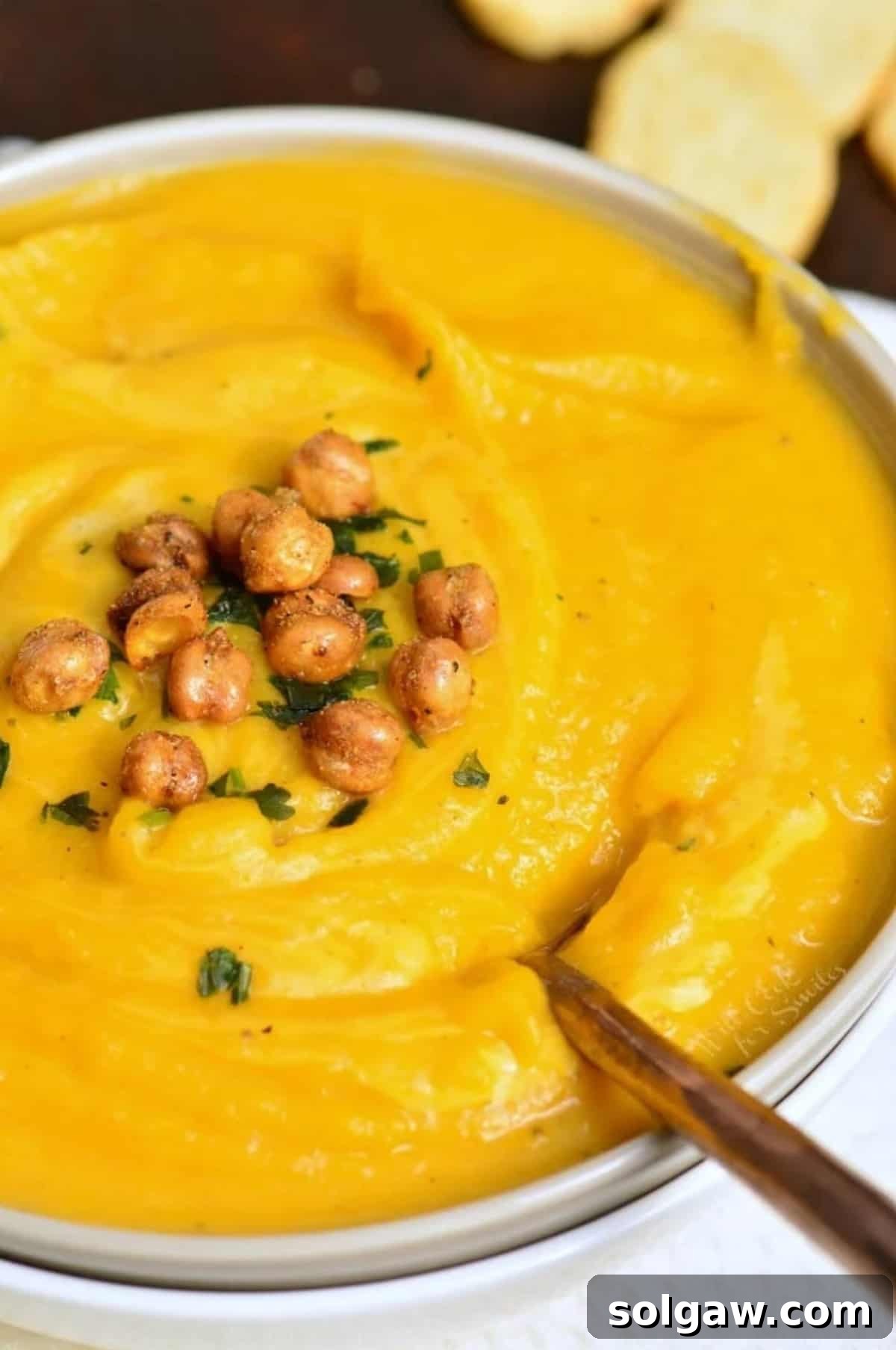 Creamy Instant Pot Butternut Soup 2 butternut squash soup in a bowl with chickpeas on top and a spoon in the bowl.