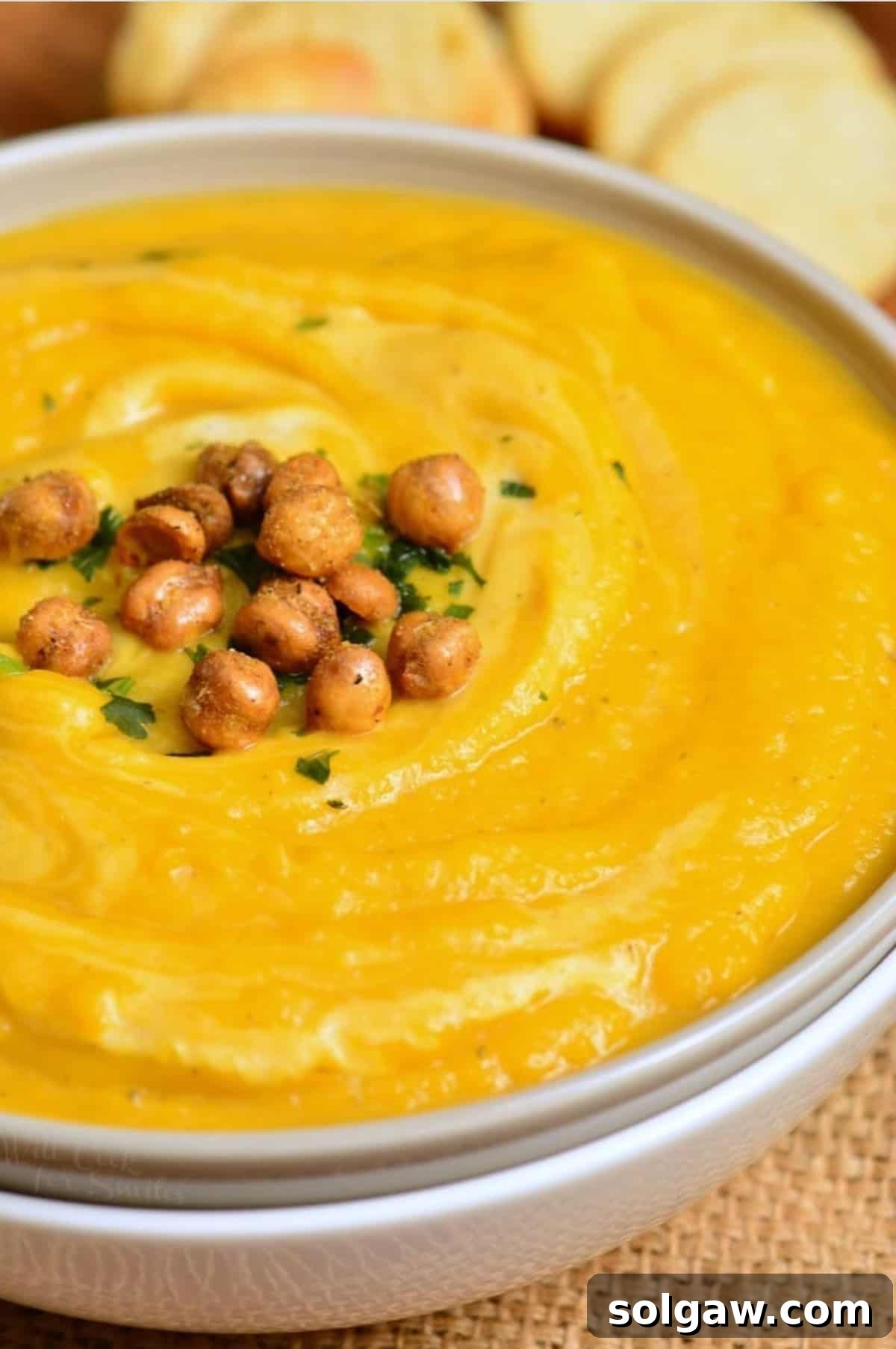 Creamy Instant Pot Butternut Soup 7 butternut squash soup in a bowl with chickpeas on top.