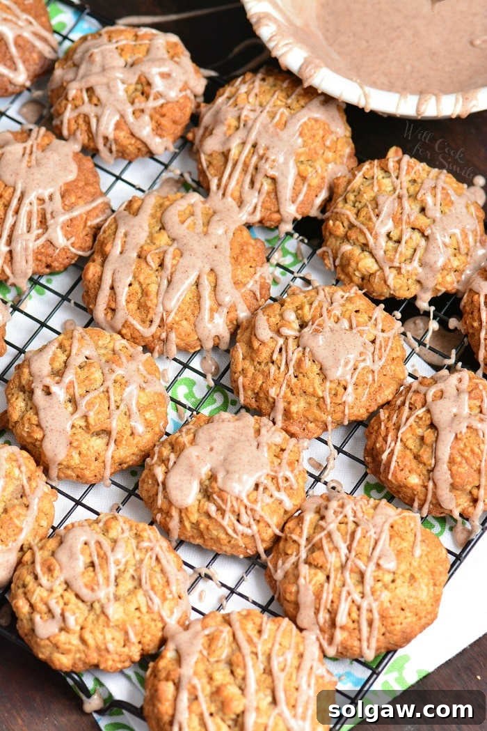 Glazed Cinnamon Oatmeal Cookies cooling on a wire rack with a rustic background.