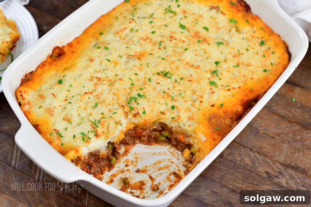Hearty Shepherd's Pie: A Comfort Food Classic 7 closeup shepherd's pie in the baking dish with some scooped out.