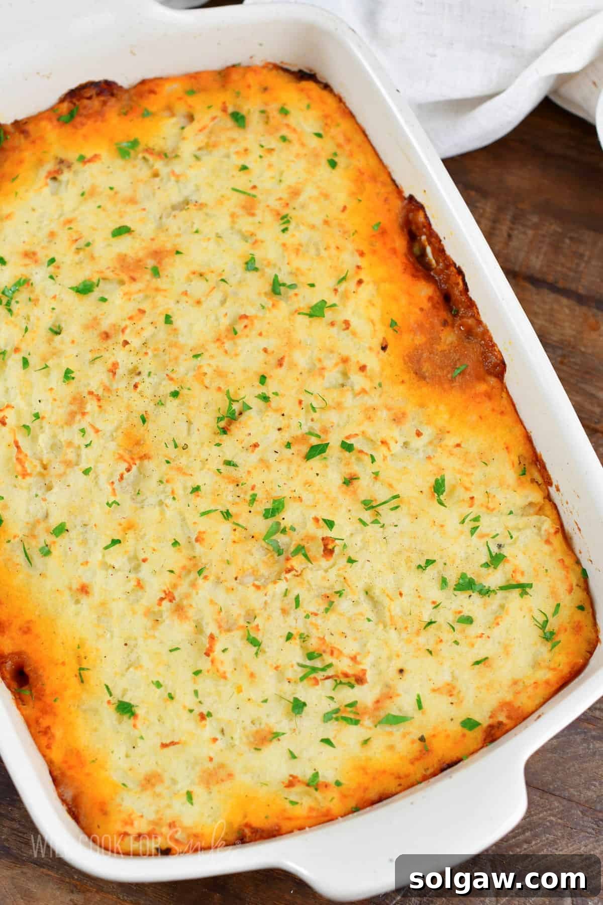 Hearty Shepherd's Pie: A Comfort Food Classic 9 top view of baked shepherd's pie in white baking dish.