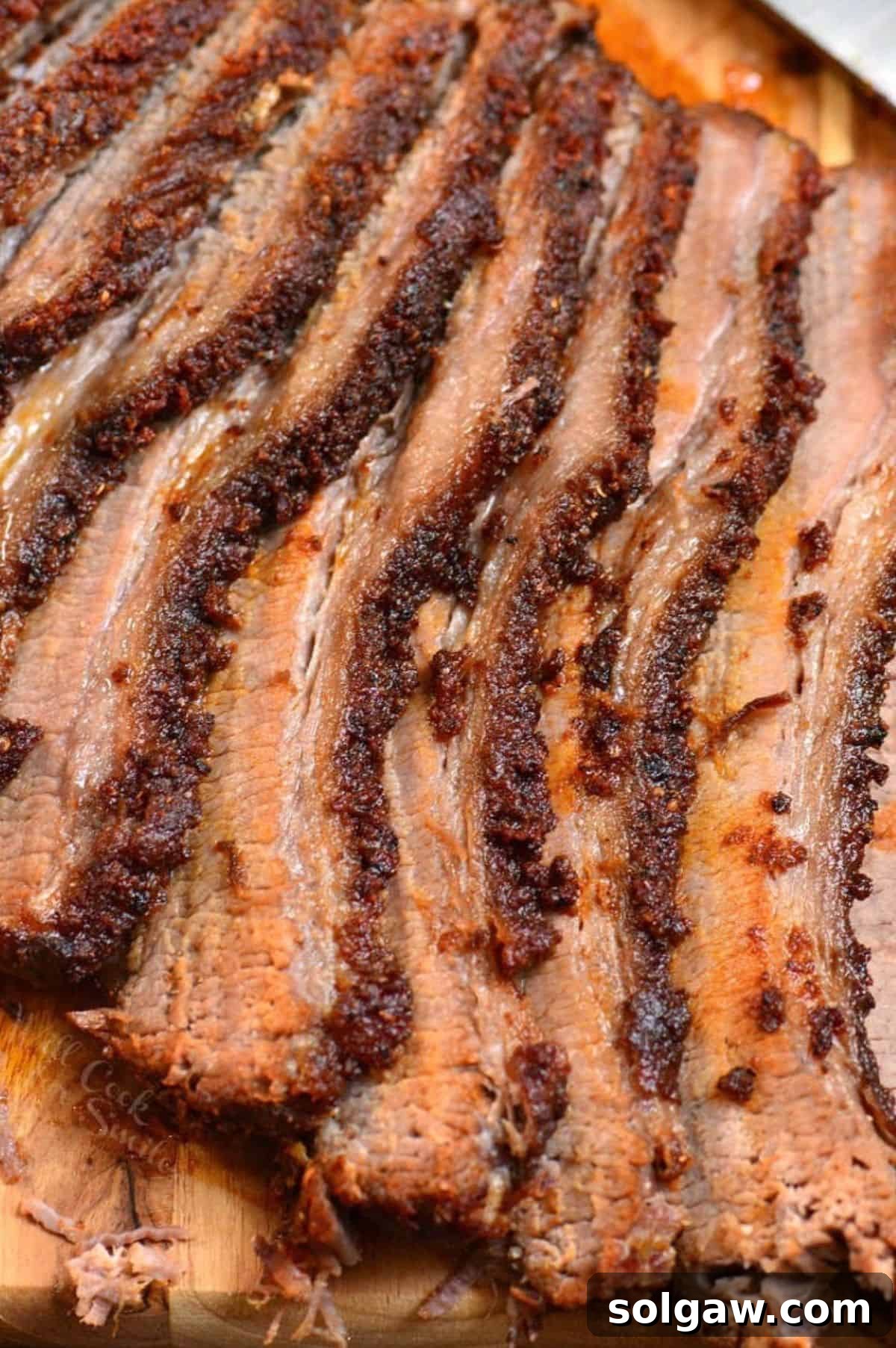 closeup sliced juicy and tender beef brisket cooked in the oven with dry rub.