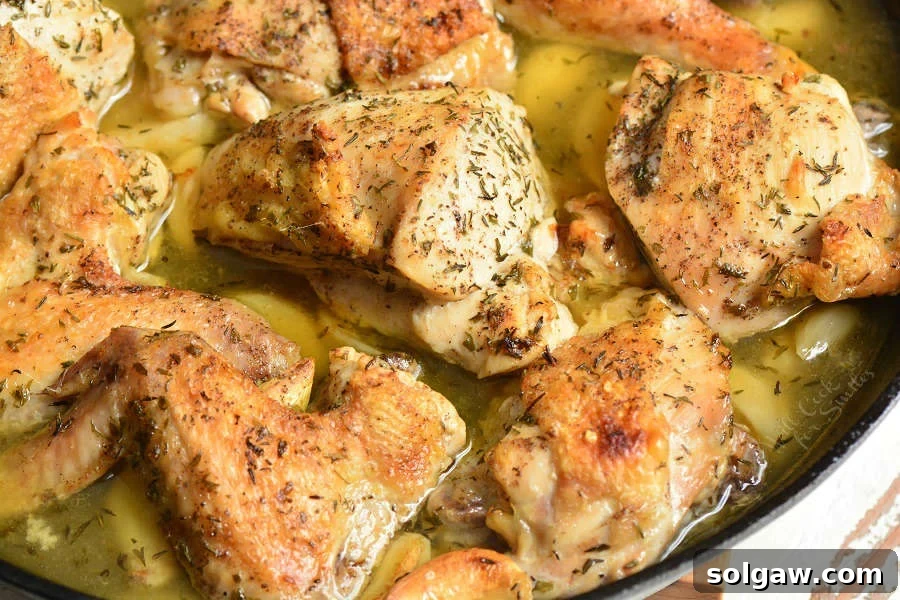 Savory Garlic Chicken 6 A vibrant overhead shot of the baked garlic chicken, beautifully golden, with a side of fresh herbs, ready for a comforting meal.