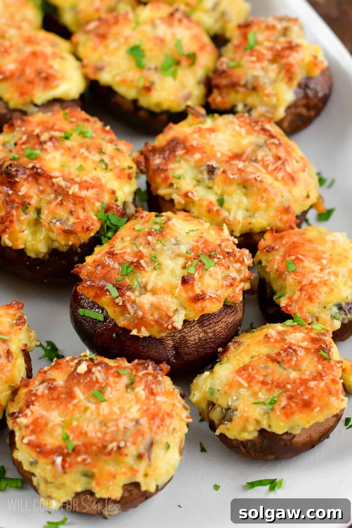 Decadent Mushroom Caps 7 several stuffed mushrooms on the platter garnished with cilantro.