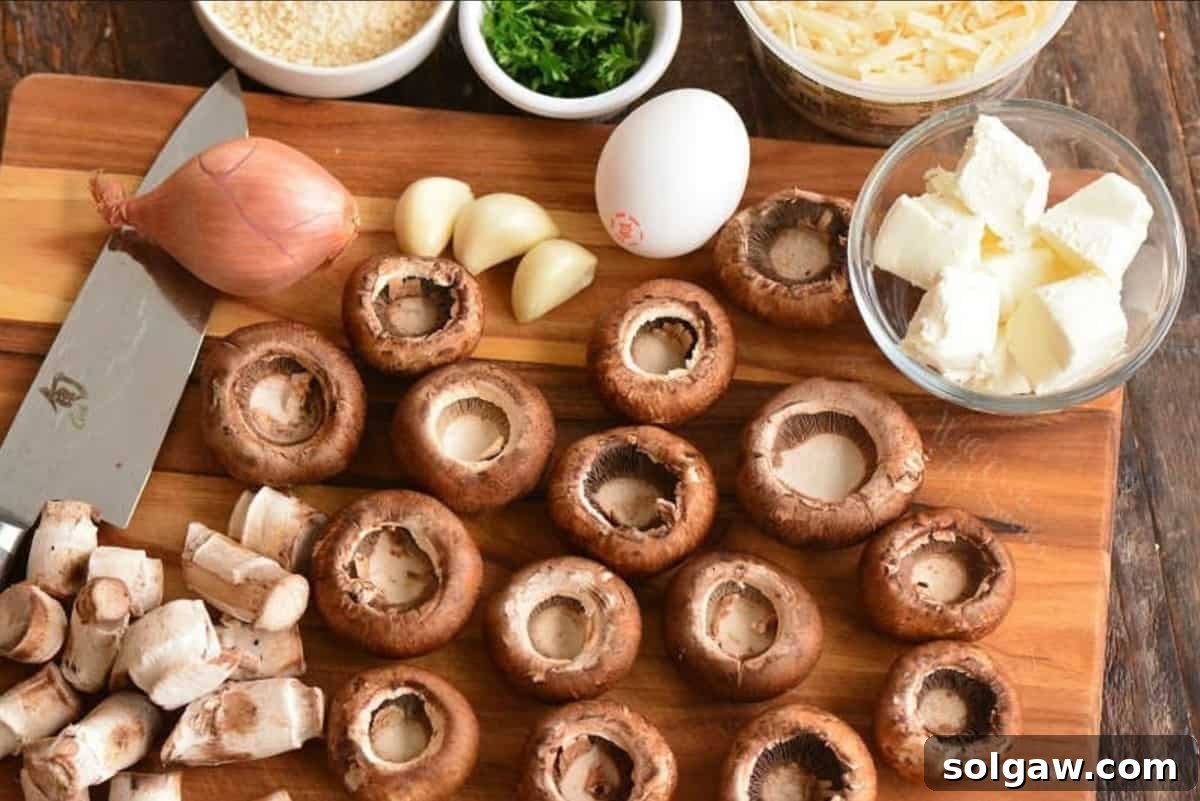Decadent Mushroom Caps 3 Mushroom caps and other fresh ingredients laid out for making stuffed mushrooms.