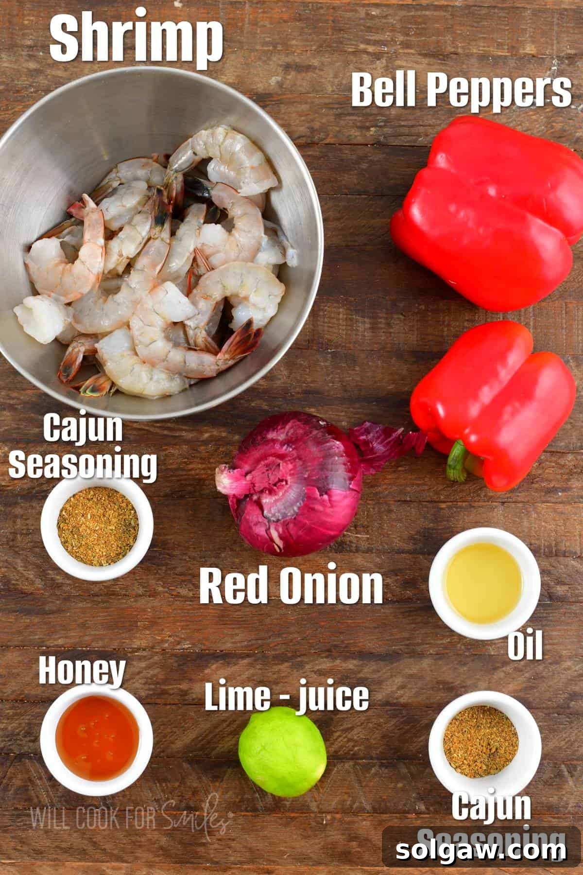 Zesty Cajun Grilled Shrimp & Garden Vegetables 3 Fresh ingredients laid out for Cajun grilled shrimp including raw shrimp, red bell peppers, sliced red onions, a fresh lime, honey, and a bowl of Cajun seasoning