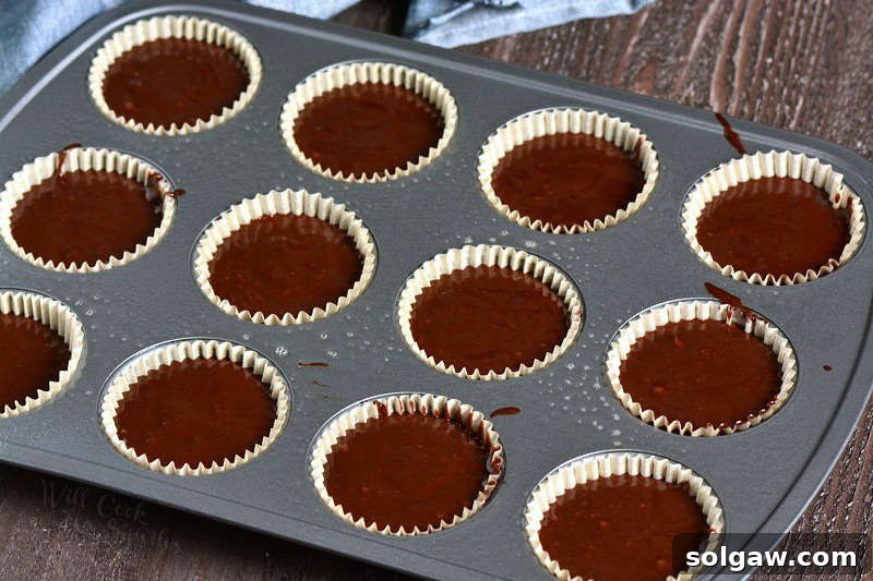 chocolate stout cupcakes batter in paper cupcake wrapper in a cupcake pan 