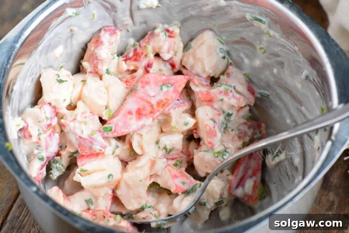 mixing lobster meat for the rolls in the mixing bowl.