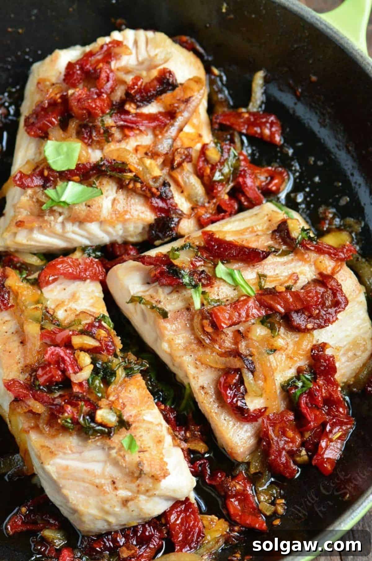 Golden Pan Seared Mahi Mahi with Bursting Tomato Basil 6 Three mahi mahi filets in the skillet with a sun dried tomato basil topping.