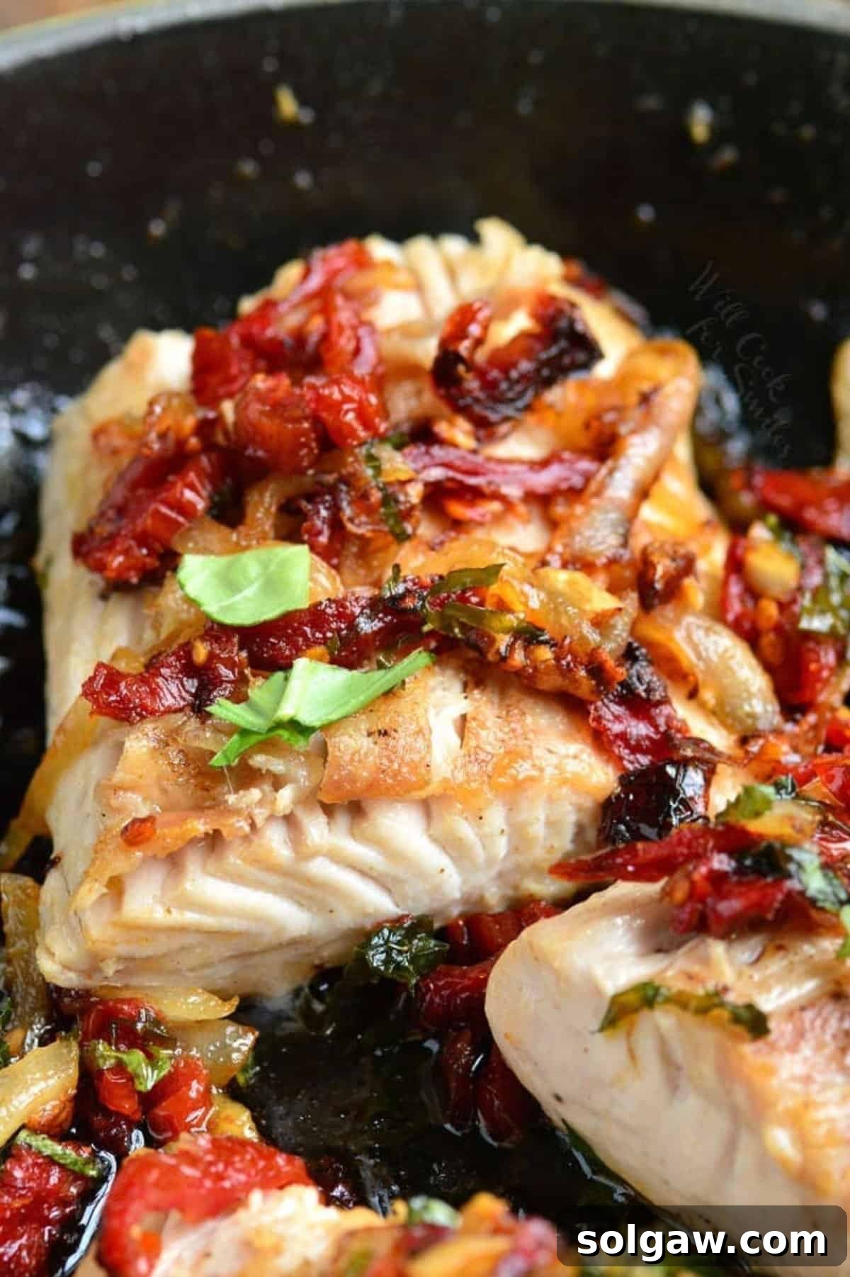 a thick juicy mahi mahi filet pan seared with sun dried tomato and basil topping.