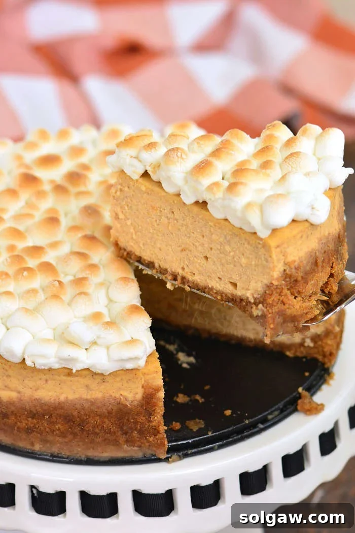 Velvet Sweet Potato Cheesecake 7 Slicing a sweet potato cheesecake on a cake stand