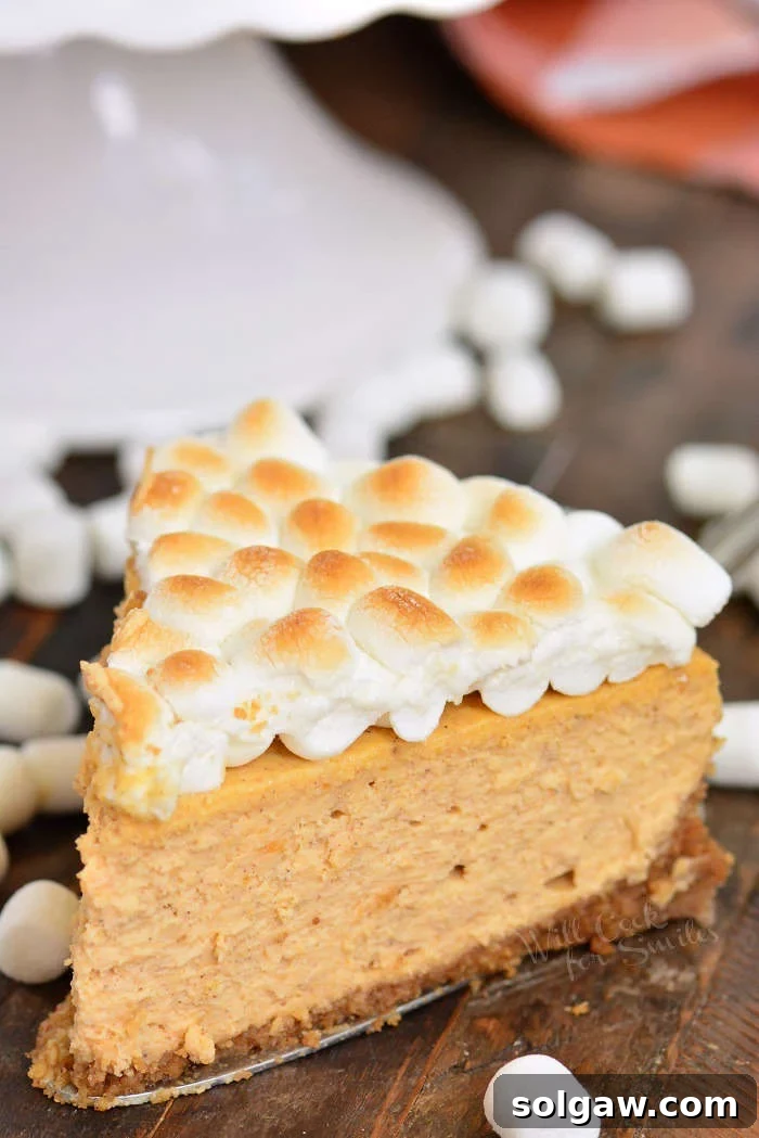 Velvet Sweet Potato Cheesecake 8 A slice of sweet potato cheesecake on a wooden cutting board
