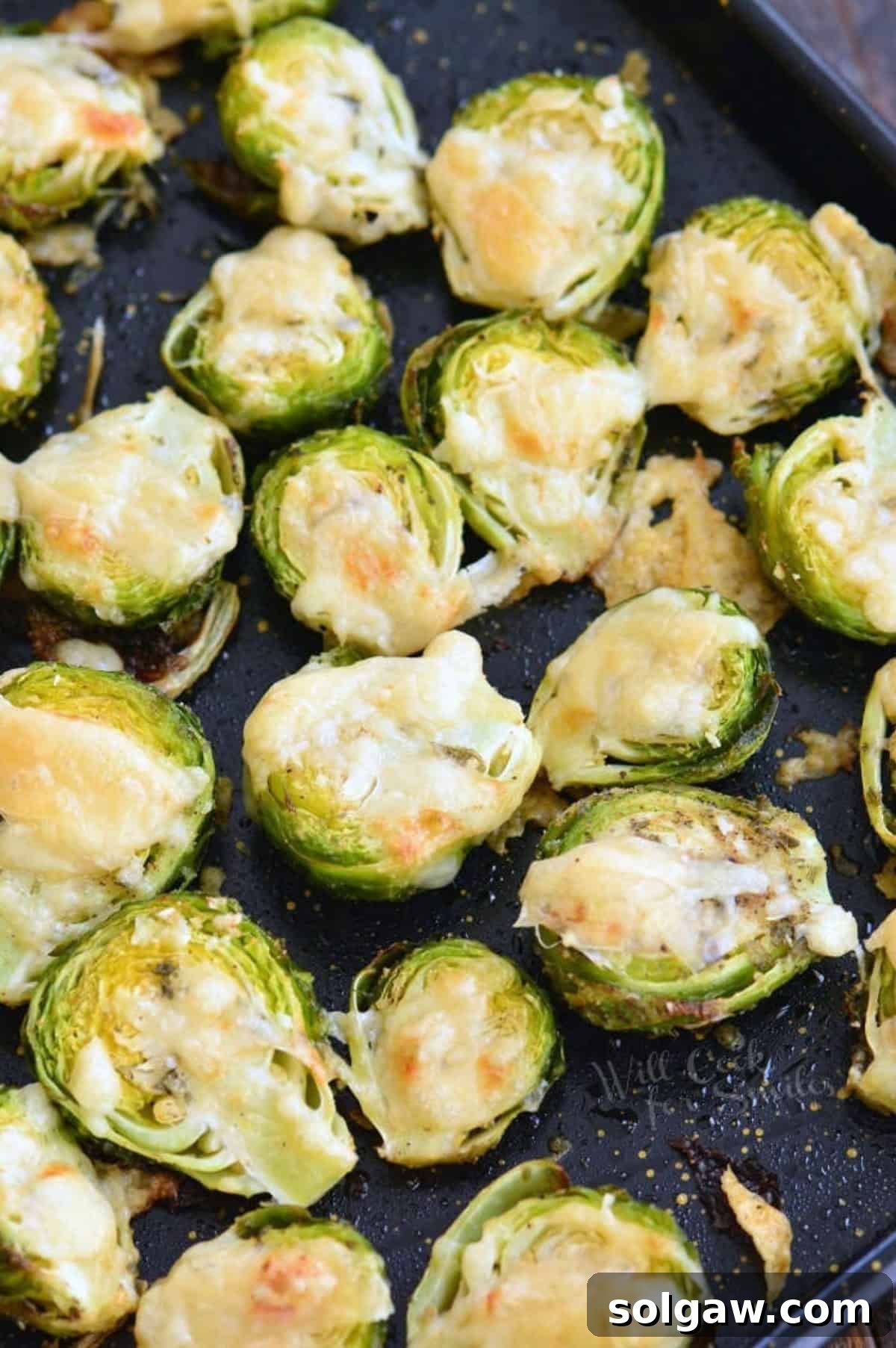 Parmesan Roasted Brussels Sprouts perfectly cooked on a baking sheet, ready to serve.