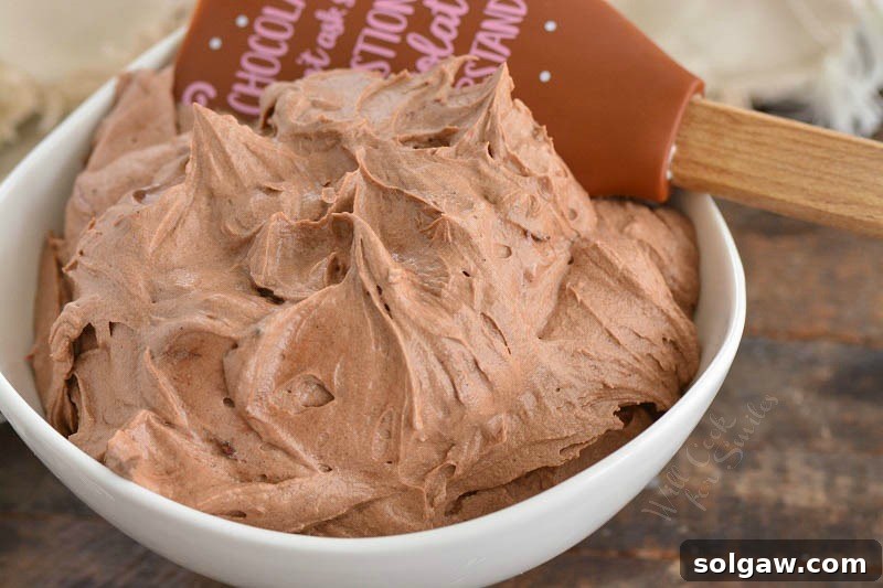 A bowl of perfectly whipped cream cheese frosting, ready to be used.