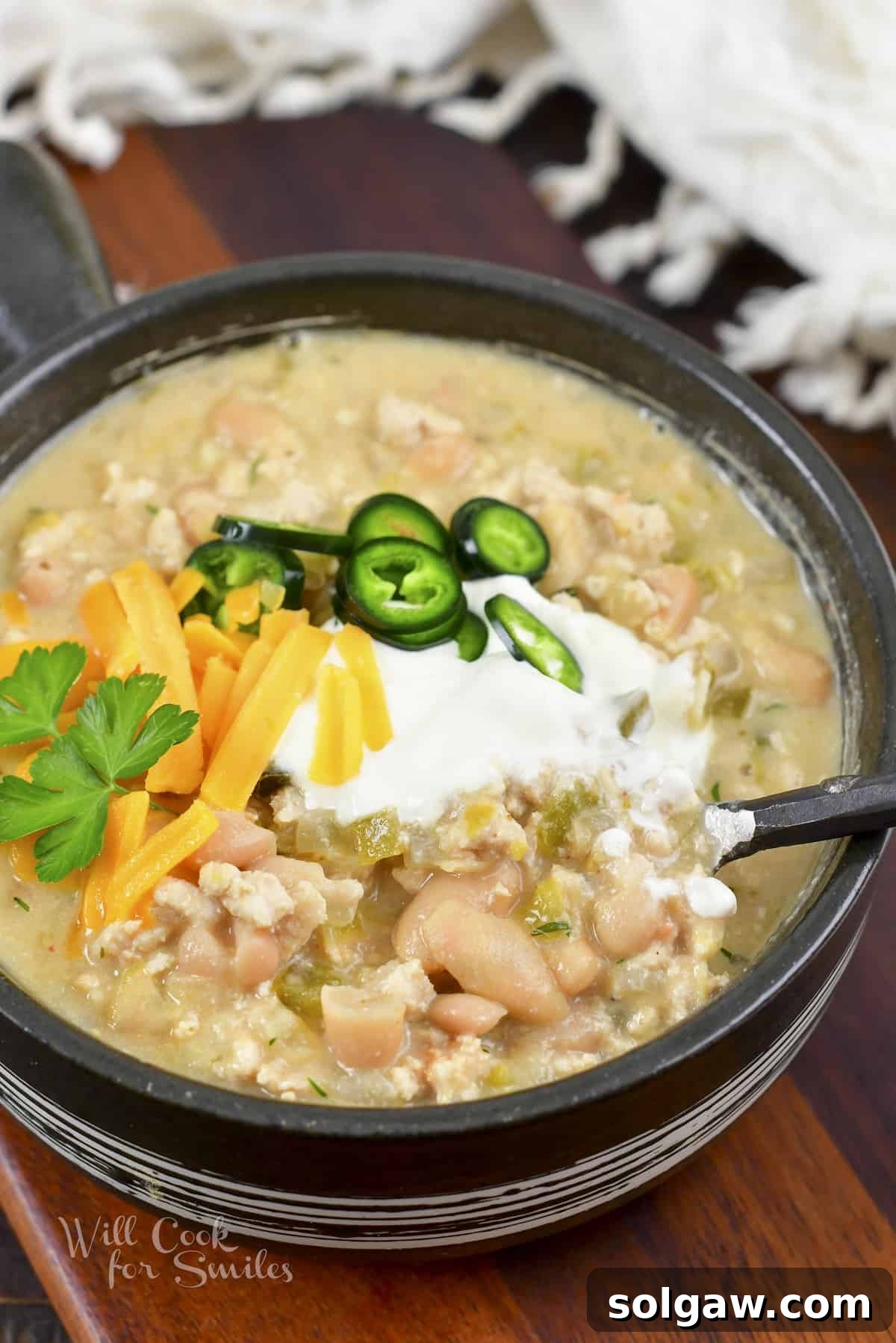 White Turkey Chili in a bowl with a spoon