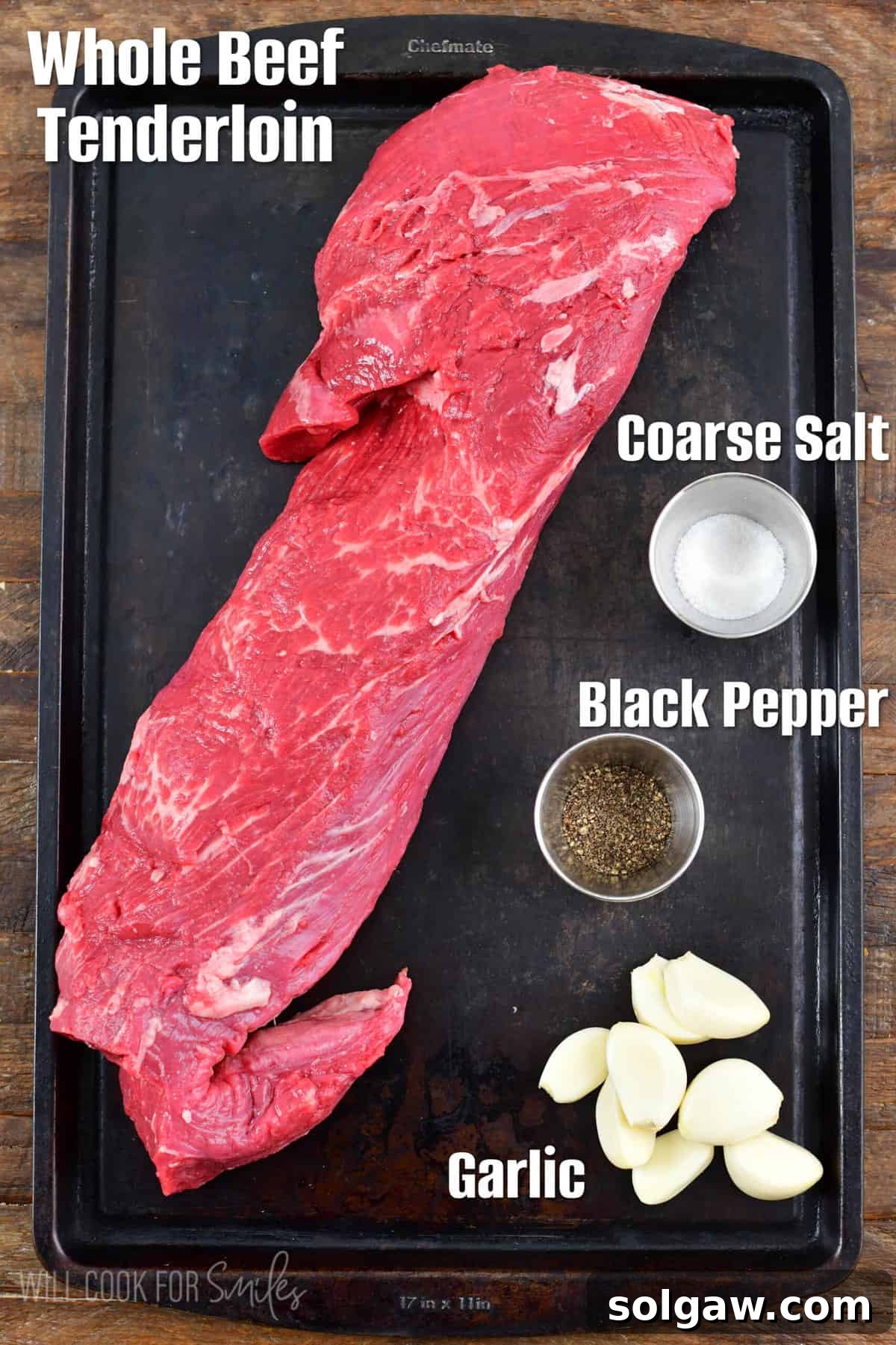 ingredients to make the beet tenderloin on a black baking sheet.